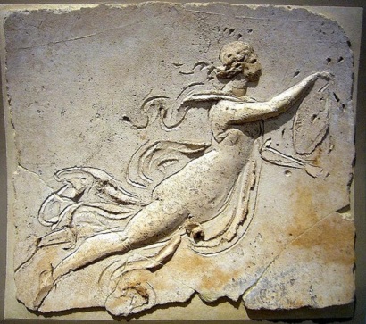 Stucco relief of a maenad holding a tympanum
